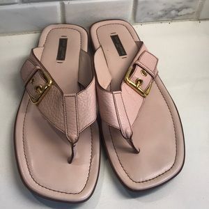 Louis Vuitton leather flip flops.
